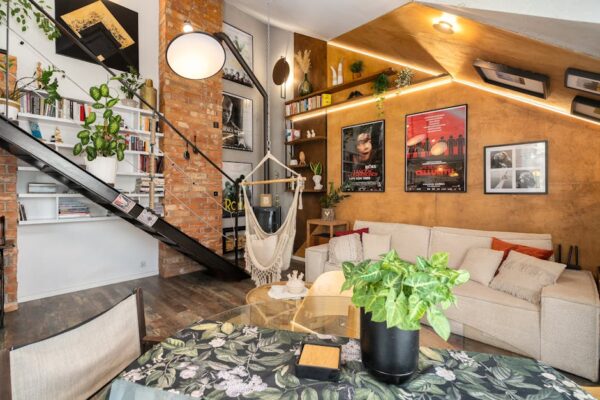 Stylish modern living room with industrial design elements, lush plants, and eclectic decor.