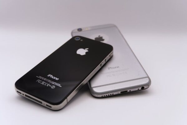 Two smartphones displayed on a white surface, showcasing modern technology.